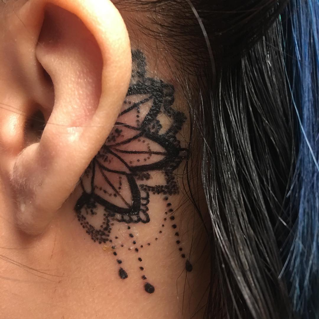 Linda mandala tatuada atrás da orelha.