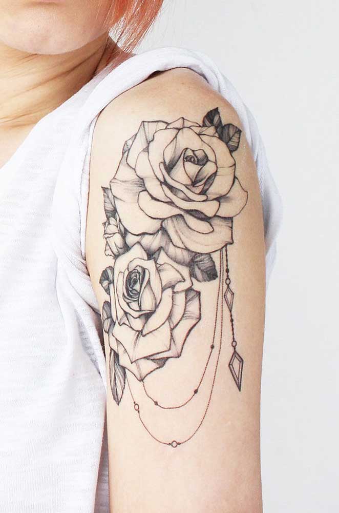 Mais uma opção de tatuagem rosa no ombro com linhas pretas.