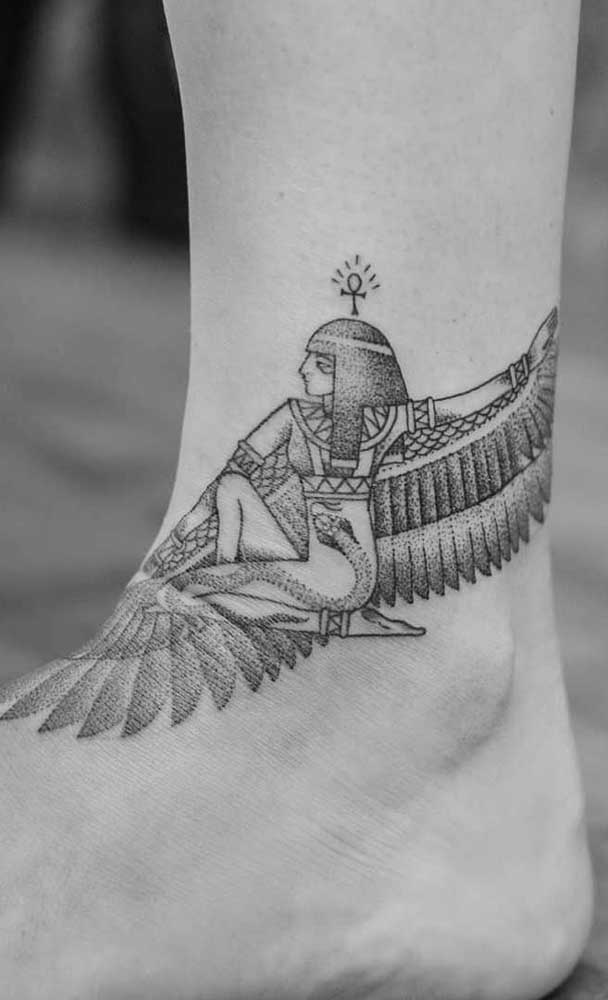 Uma Cleópatra de asas com cruz Ansata na cabeça e uma serpente subindo pelo seu corpo: uma tatuagem de grande impacto visual