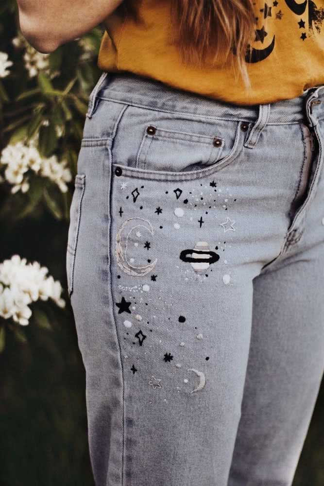 Lua, planetas e estrelas na calça jeans