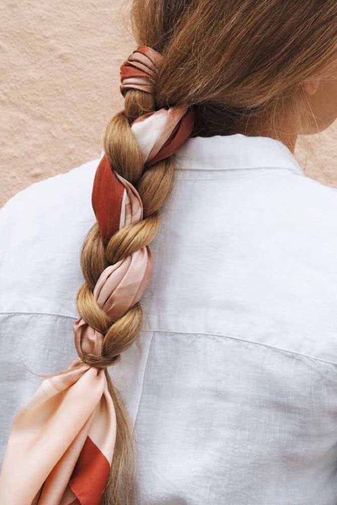 Uma ideia para inovar e sair do básico com a trança tradicional baixa: use um lenço colorido no lugar de uma das mechas. 