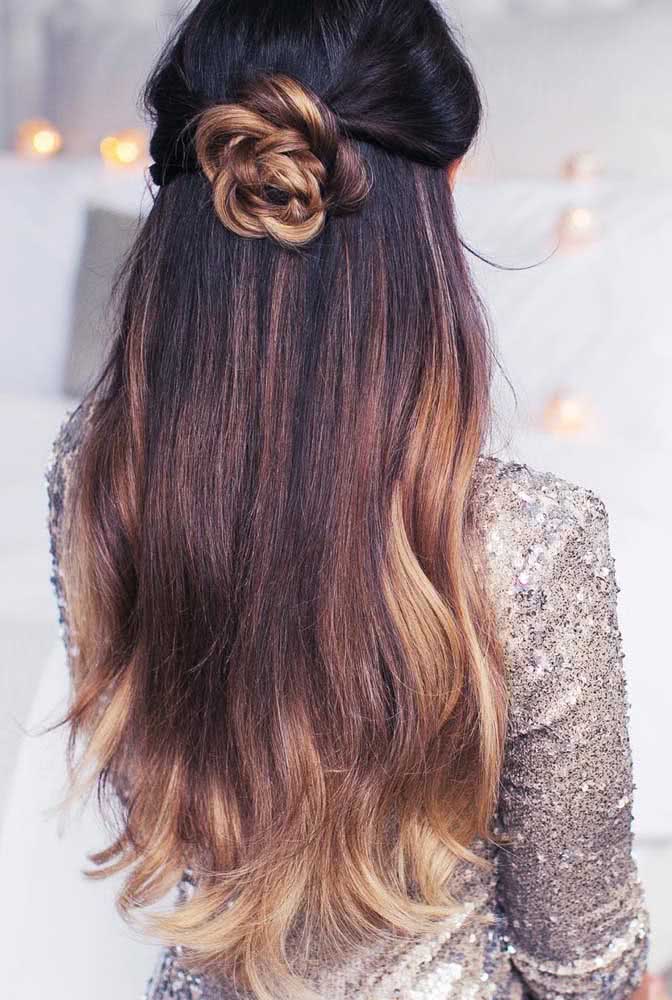 Junte as mechas frontais na parte de trás do cabelo, faça uma trança soltinha e enrole-a num coque, parecendo uma flor para decorar o seu cabelo solto.