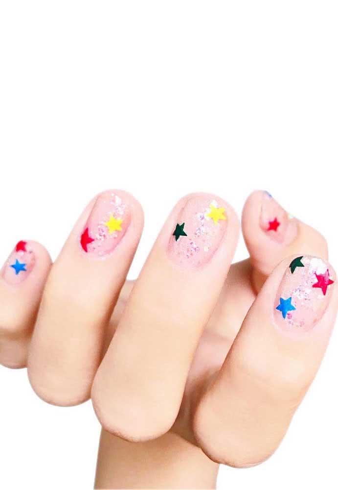 Sabe aquelas estrelinhas do tempo da escola? Cole-as nas unhas junto com o glitter