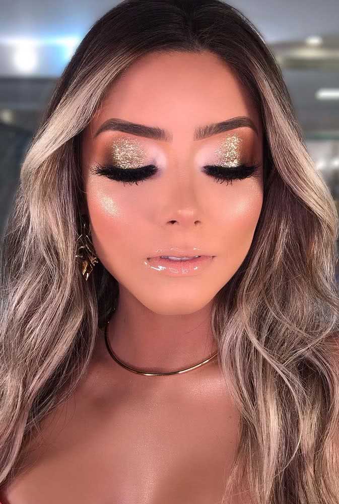 E por falar em brilho, dá uma olhada nesta maquiagem dourada com sombra glitter que contrasta com a profundidade do preto do delineador e da máscara para os cílios. 