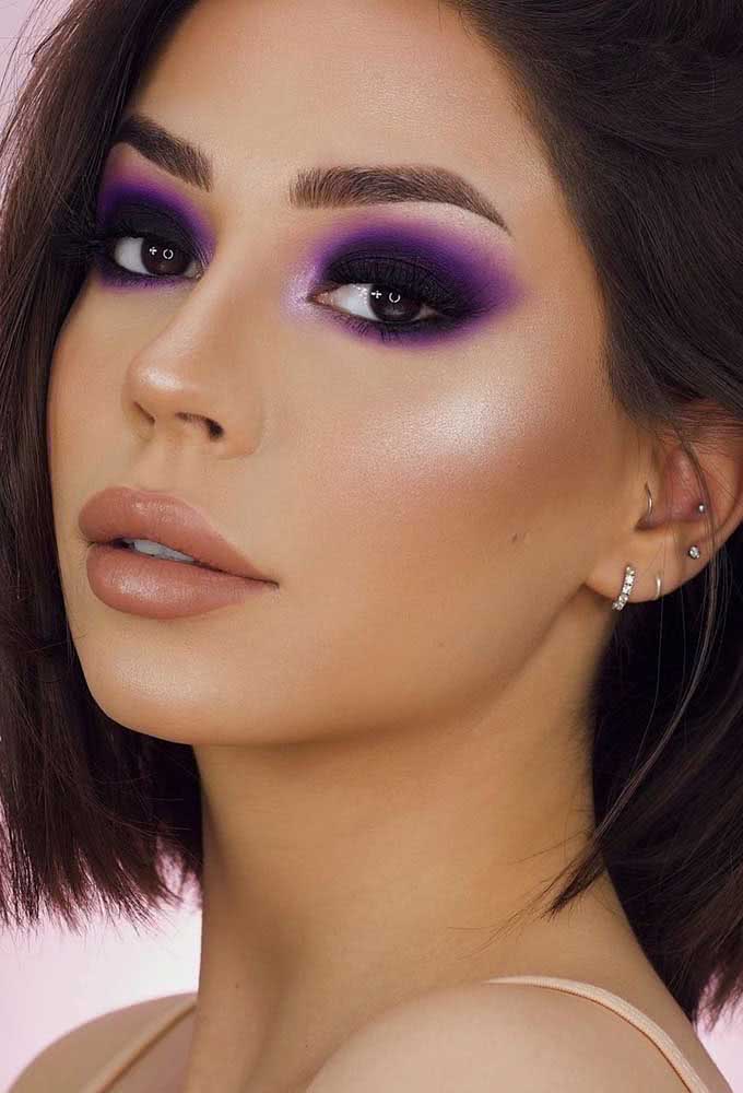 Invertendo um pouco a ordem das coisas, neste cut crease roxo neon os tons escuros se concentram na pálpebra móvel, enquanto os tons mais claros se concentram na pálpebra fixa e no canto interno do olho. 