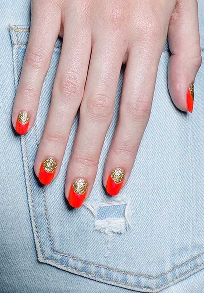 Um visual glam com unha francesinha vermelha com um toque de dourado com glitter na meia-lua