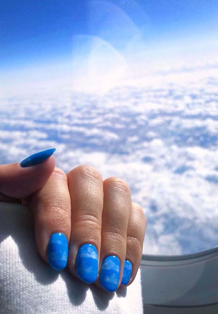Ou você pode se inspirar num céu cheio de nuvens para compor as suas unhas decoradas azuis. 