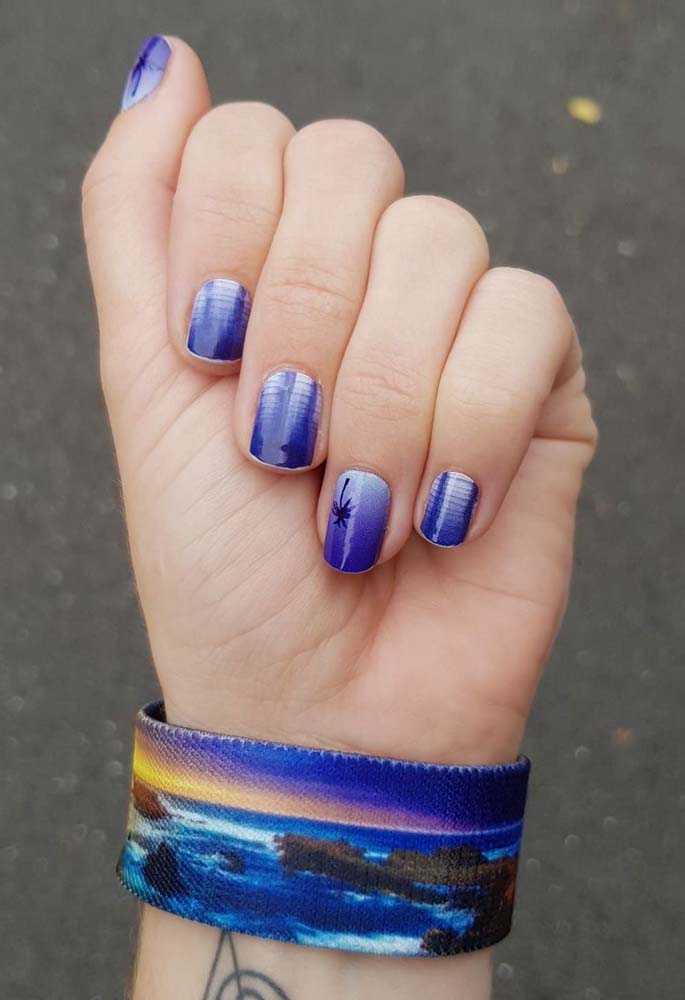 Unhas decoradas azuis royal no maior estilo praiano, com direito à efeito tie dye e desenho de palmeira.